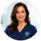 Friendly WheelHouse Health care team member in navy medical scrubs smiling for membership consultation support
